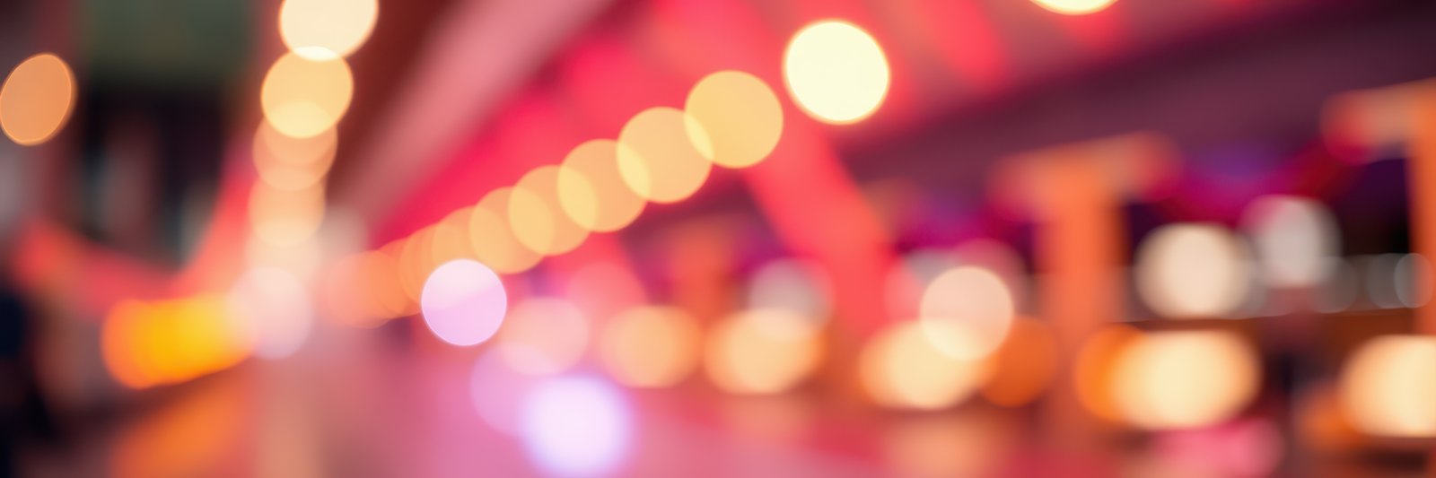 Colorful bokeh lights create a vibrant atmosphere in a lively venue during an evening gathering with friends